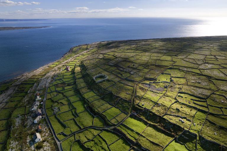 An aerial photograph of the coast, stonewalls and fields of Inis Oírr from above