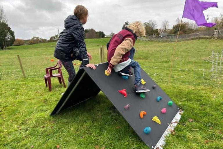 kids playing on playground climbing frame