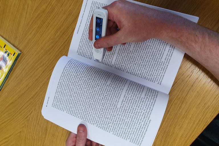 Image of someone using a c-pen reader