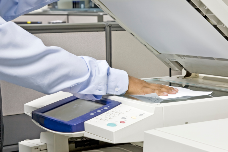 Image of man using photocopier