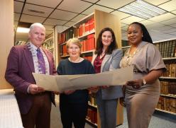 Library employees plus local dignitaries holding drawing by Peader O'Dowd