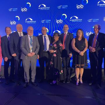 People receiving the award on stage