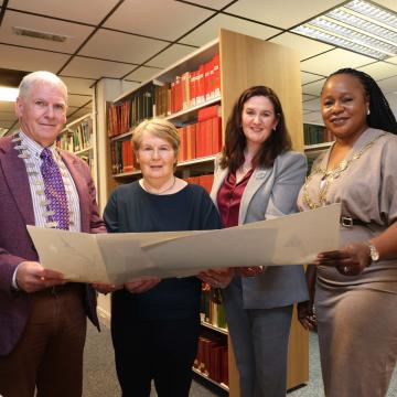 Library employees plus local dignitaries holding drawing by Peader O'Dowd