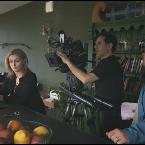 A behind the scenes photograph of the Smother TV drama set. Actor Dervla Kirwan and film crew in a kitchen