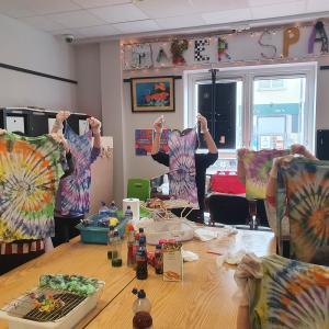 Image of children holding up tie-dye t-shirts in Ballybane MakerSpace