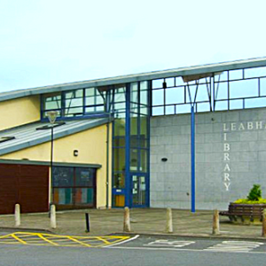 Image of westside library, modern yellow building wtih stone and blue pillars