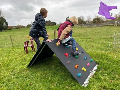 kids playing on playground climbing frame