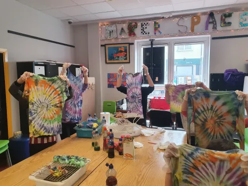 Image of children holding up tie-dye t-shirts in Ballybane MakerSpace