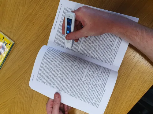Image of someone using a c-pen reader