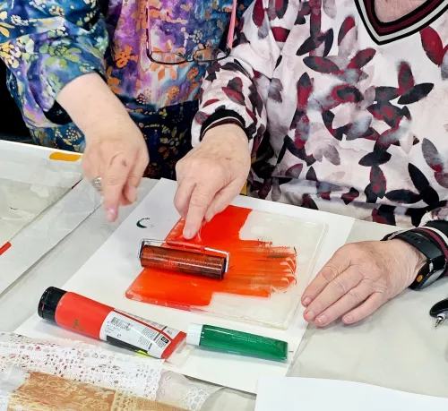 hands using paint rollers